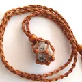 Handmade adjustable woven net pouch necklace featuring a raw natural crystal stone pendant - Rock / Brown