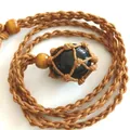 Hand-woven adjustable net pouch necklace featuring a polished black natural crystal stone - Obsidian / Brown