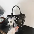 Stylish black and white polka dot handbag featuring a large lace bow and note charm - With Pendant / Black