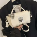 Fashionable creamy white textured mini flap handbag with pearl handle and pyramid lock - With Charm / White