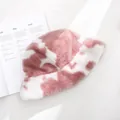 Detail of soft pink cow print faux fur bucket hat on magazine background - 55-58cm / Pink
