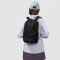 Black outdoor sports backpack with bungee cord detailing worn by a female model - Obsidian Black