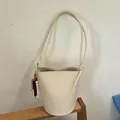 Elegant cream minimalist woven bucket bag with large capacity and braided strap - With Charm / White
