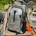 Silver lightweight waterproof hiking backpack showcased in a scenic outdoor camping setup - Gray