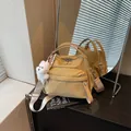 Modern yellow checkered crossbody handbag with cute white dog plush charm accessory - With Charm / Khaki
