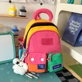 Detailed close-up of a colorful patchwork student backpack with a cute plush charm - With Pendant / Rose Red