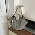 Large capacity woven straw beach tote bag with colorful charm on a wooden desk - With Pendant / Green
