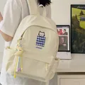 Cream-white student backpack featuring cat embroidery and moon keychain lifestyle view - With Charm / White