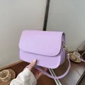 Close-up view of a minimalist lavender purple small square bag with fine stitching details - Purple