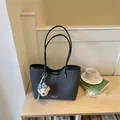 Elegant charcoal grey large capacity tote bag with bear charm on a minimalist wooden desk - With Charm / Black