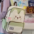 Detailed view of the cute cat-themed green school backpack with a plush bunny charm - Green