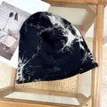 Close-up of a stylish tie-dye slouchy beanie hat with trendy black and white patterns - 55-60cm / Tie-dye Black