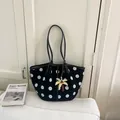 Stylish black and white polka dot canvas tote bag with a yellow palm tree charm accessory - With Charm / Black