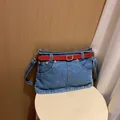 Unique blue denim shoulder bag featuring a stylish red belt and metal buckle detail - Light Blue