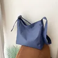 Casual blue and white checkered nylon crossbody bag with spacious interior for daily use - Blue