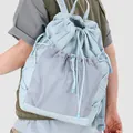 Fashionable light blue drawstring backpack for women featuring a grey mesh front pocket - Blue
