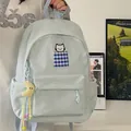 Detailed view of a light blue student backpack with cat embroidery and a moon charm - With Charm / Blue