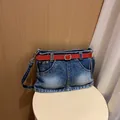 Unique denim skirt-style shoulder bag with a bright red belt and silver hardware - Dark Blue