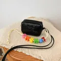Detailed view of a black mini crossbody bag with colorful letter beads on the strap - Black