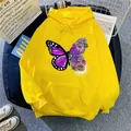 Close-up detail of butterfly and flower graphic print on yellow oversized hoodie - Yellow