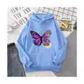 Casual light blue oversized hoodie featuring a unique butterfly and floral pattern print. - Sky Blue
