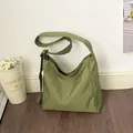 Casual large capacity green grid nylon hobo bag with an adjustable shoulder strap. - Green