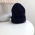 Close-up detail of navy blue distressed knit beanie with silver safety pin and rings - 55-58cm (Elastic) / Navy Blue