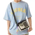 Detailed macro view of a lightweight crossbody bag featuring a clear pocket and star charm - With Charm / Black