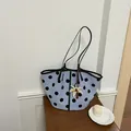 Stylish light blue polka dot tote bag featuring a palm tree pendant on a wooden surface - With Charm / Blue