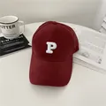 Classic deep burgundy baseball cap with a white embroidered letter P on a desk - 58-65cm (Adjustable) / Burgundy