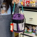 Purple nylon drawstring bucket bag with white mesh detail and cute apple charm pendant. - With Charm / Purple