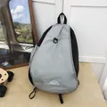 Macro detail view showing grey grid pattern and mountain logo on a lightweight hiking bag - Black Grey Patchwork