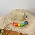 Minimalist cream mini crossbody square bag featuring a colorful alphabet bead strap detail - Yellow