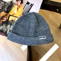Close-up of grey knitted beanie with PPSW letter tag for kids and toddlers - 3 Years+ to Adult / Gray