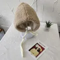 Close-up of cozy beige sherpa earflap hat with soft fleece lining on display - 56-58cm / Beige