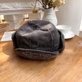 Detailed view of a dark grey plush earflap hat for winter warmth on a wooden table - 55-58cm / Gray
