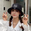 Trendy black women's bucket hat with cute white bunny ears embroidery for sun protection - 55-59cm / Black