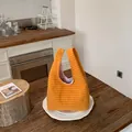 Detailed view of an orange checkered large capacity women's bucket bag in a rustic kitchen - Yellow
