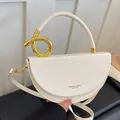 Elegant white semi-circle saddle handbag with a luxury gold metal ring handle - White