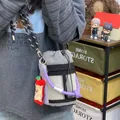 Minimalist grey mesh crossbody bucket bag with purple rope handle and apple charm - With Charm / Gray