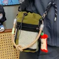 Minimalist green nylon bucket bag with white mesh pocket and plush apple pendant - With Charm / Green