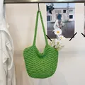 Artisan green crochet shoulder bag with intricate woven texture and daisy detail - Green
