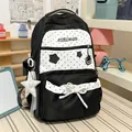Detailed view of cute black and white polka dot student backpack with star print and bow - With Charm / Black