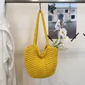 Detailed view of vibrant yellow handmade crochet shoulder bag with intricate knit texture - Yellow