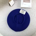 Top view of a cozy blue knitted beret hat featuring a unique letter patch detail - 55-60cm / Sapphire Blue