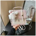 Detail view of pink polka dot backpack with strawberry embroidery and bunny charm - Pink
