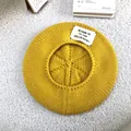 Detailed macro view of yellow knitted wool beret showing the SEASON 13 patch design. - 55-60cm / Yellow