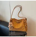 Detail of large brown suede tote bag with bear charm and embossed MIKAXIQI logo. - With Pendant / Brown
