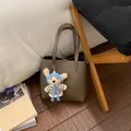 Chic pebble grain leather bucket bag with cute knitted bear charm for daily commuting - With Pendant / Gray