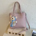Elegant pink bucket bag with lychee grain texture and a cute knitted bear charm accessory - With Pendant / Pink
